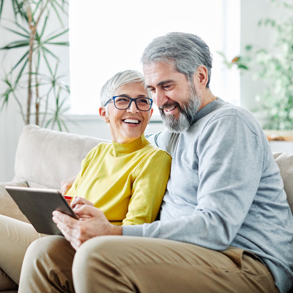 senior couple using tablet Atlanta Oral & Facial Surgery