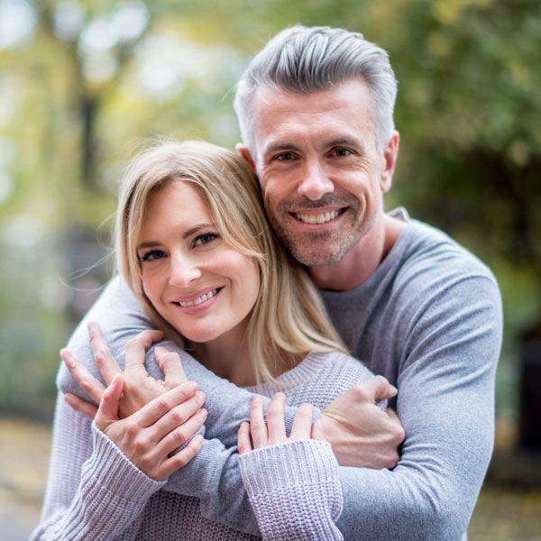 smiling middle aged couple Atlanta Oral & Facial Surgery