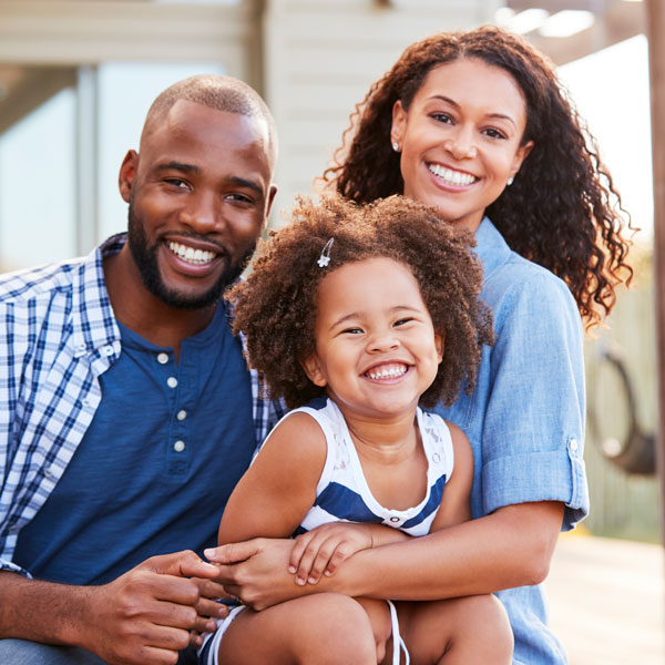 family of three smiling Atlanta Oral & Facial Surgery