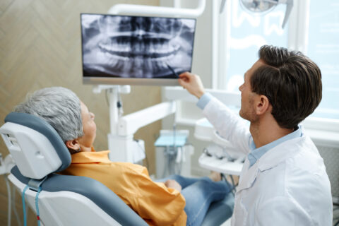 dentist pointing at tooth X-ray