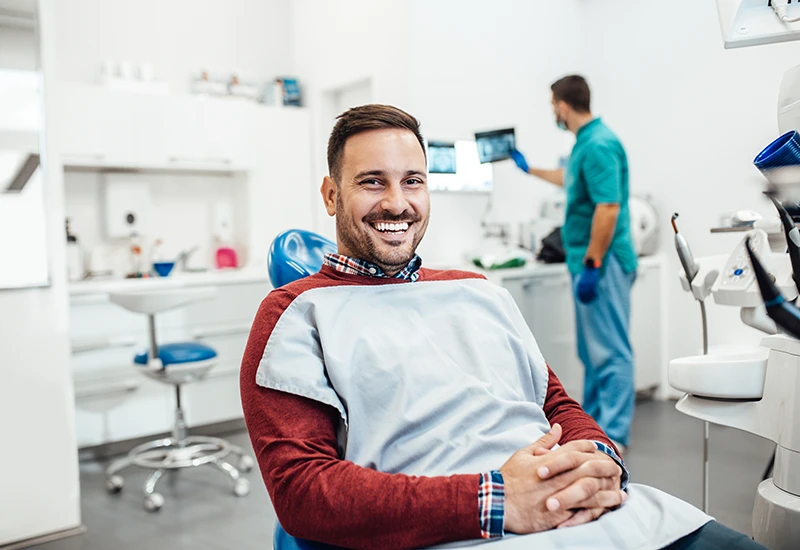 Patient in Atlanta dental office smiling before getting a tooth extraction